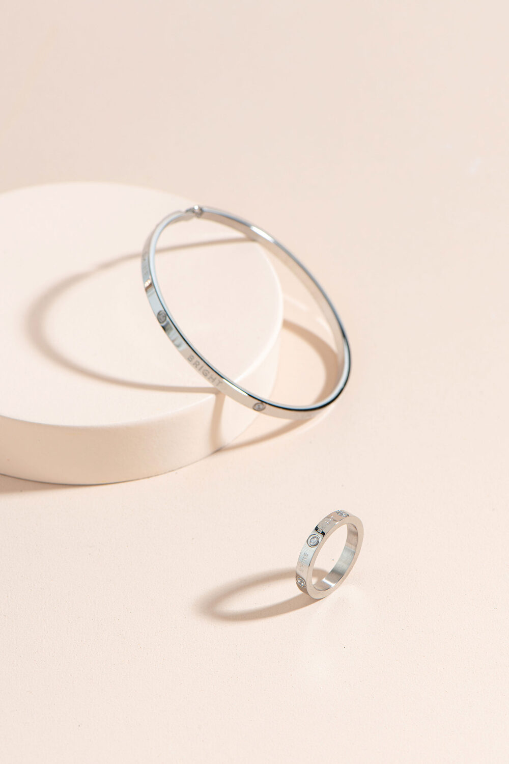 A stack of BE. Bangles and a ring, gold and silver.